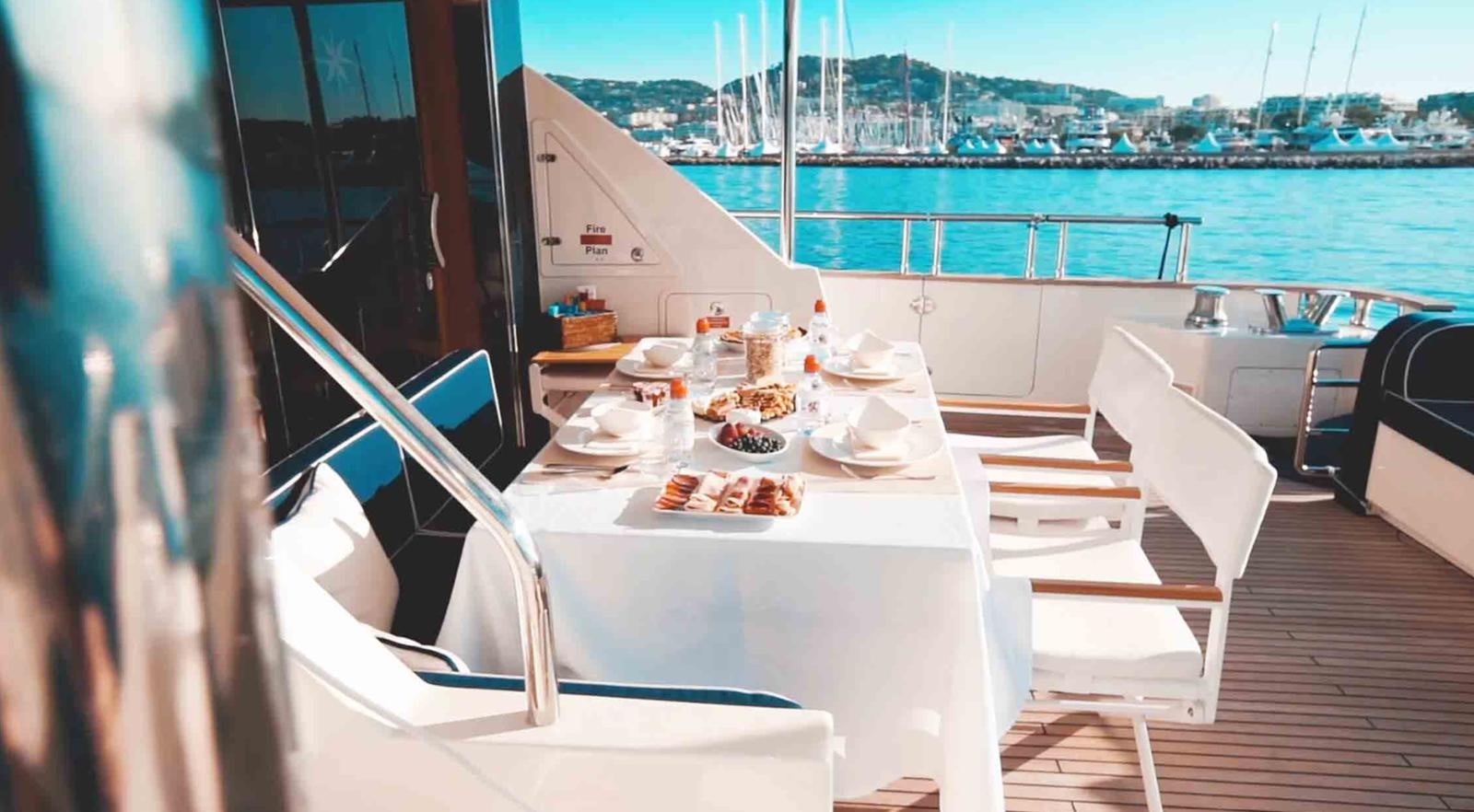 a table with food on it aboard COUACH 3000 FLY Yacht for Sale
