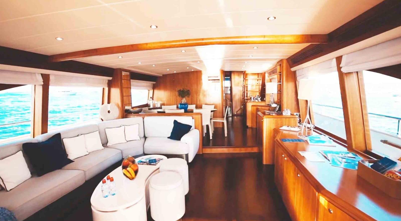 a living room with a large window aboard COUACH 3000 FLY Yacht for Sale