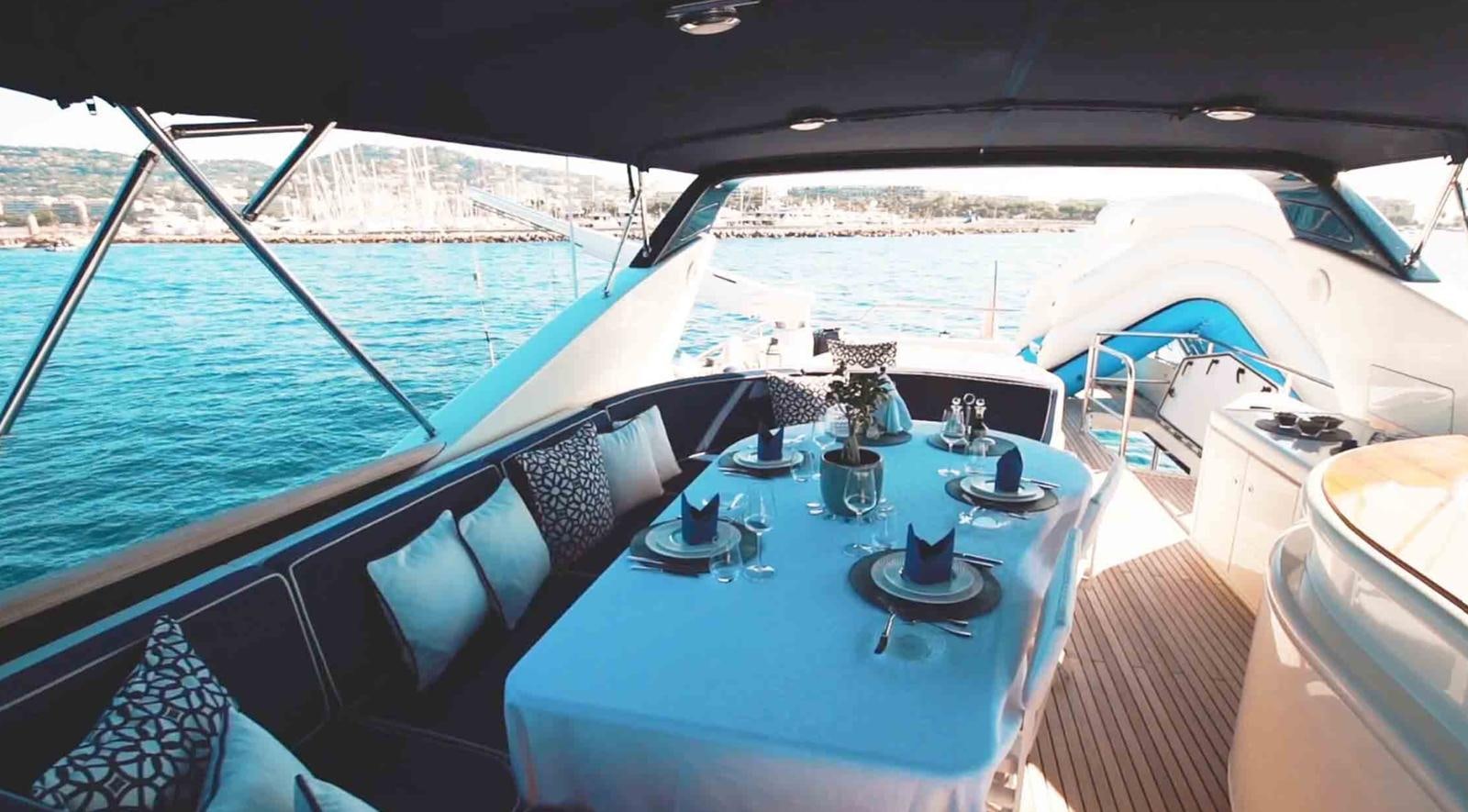 a boat with a table and chairs aboard COUACH 3000 FLY Yacht for Sale