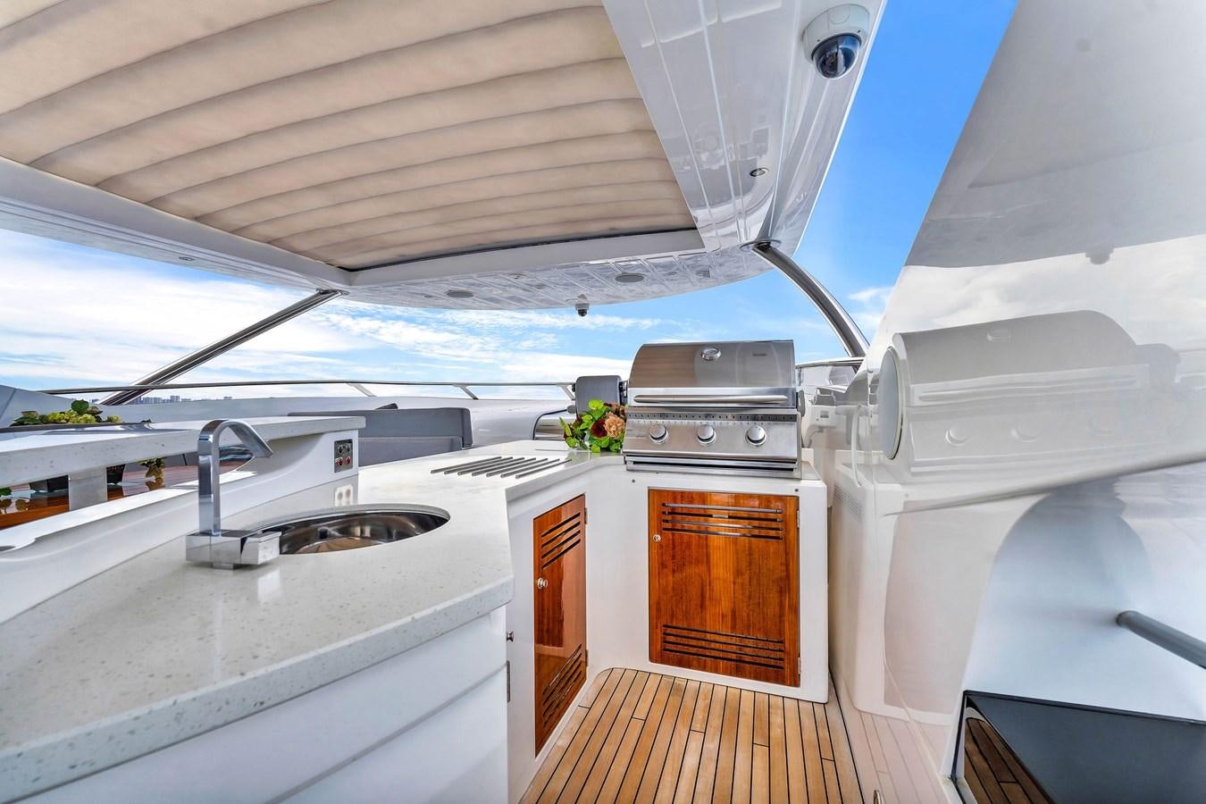 a small kitchen with a large window aboard 2018 SUNSEEKER 95 YACHT Yacht for Sale
