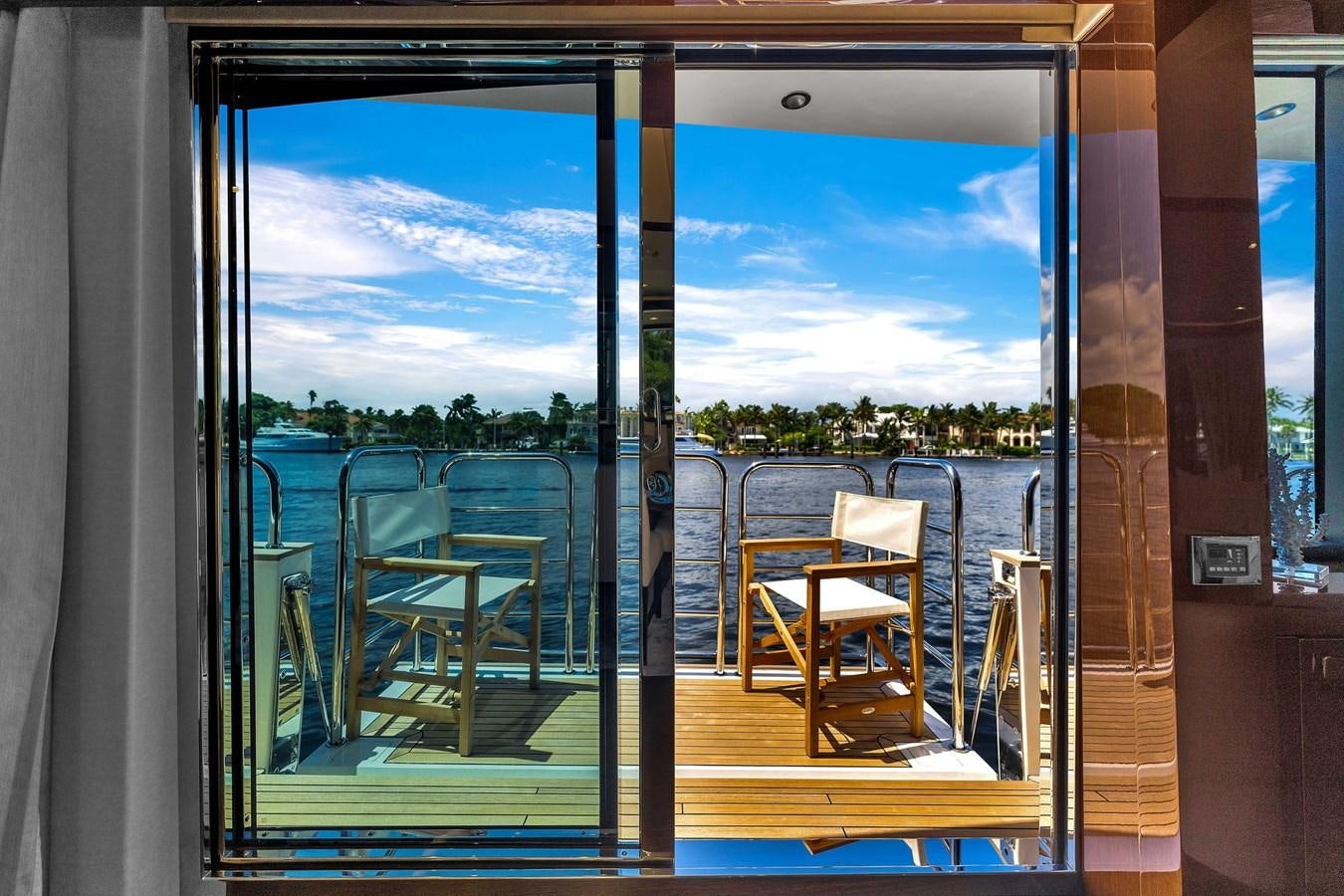 a balcony with a view of trees and a body of water aboard 2018 SUNSEEKER 95 YACHT Yacht for Sale