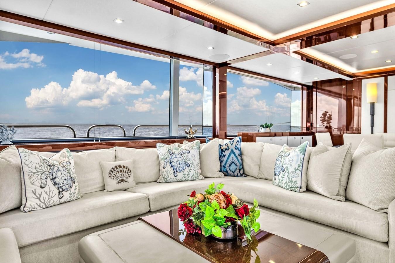 a couch with pillows and flowers aboard 2018 SUNSEEKER 95 YACHT Yacht for Sale