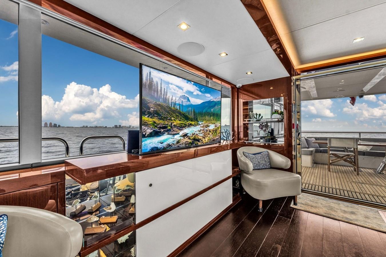 a room with a large window and a wood floor aboard 2018 SUNSEEKER 95 YACHT Yacht for Sale