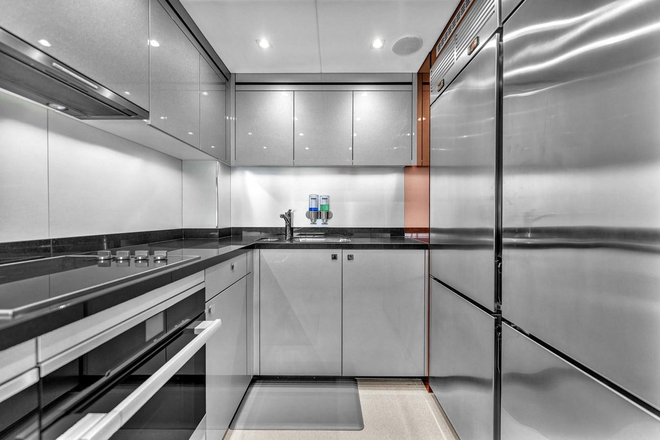 a kitchen with stainless steel appliances aboard 2018 SUNSEEKER 95 YACHT Yacht for Sale