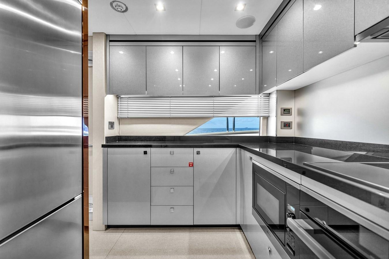 a kitchen with white cabinets aboard 2018 SUNSEEKER 95 YACHT Yacht for Sale