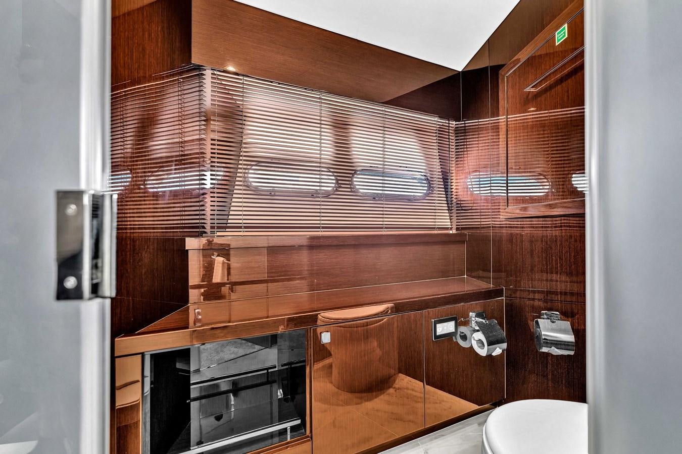 a bathroom with wooden cabinets aboard 2018 SUNSEEKER 95 YACHT Yacht for Sale