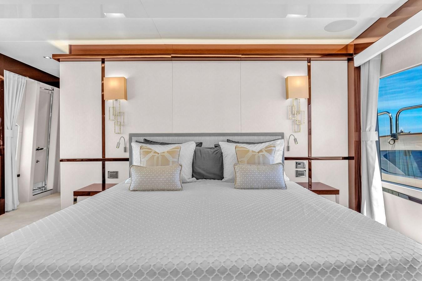 a bed with pillows and a mirror aboard 2018 SUNSEEKER 95 YACHT Yacht for Sale
