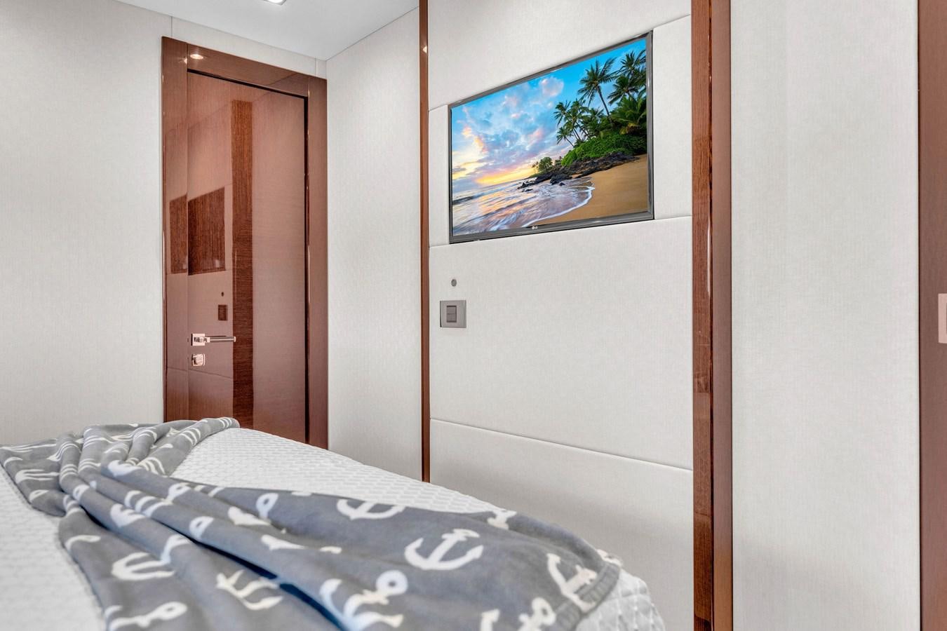 a bed with a painting on the wall aboard 2018 SUNSEEKER 95 YACHT Yacht for Sale