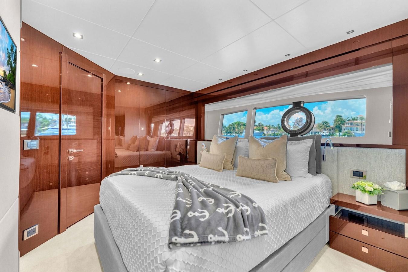 a bedroom with a bed and a mirror aboard 2018 SUNSEEKER 95 YACHT Yacht for Sale