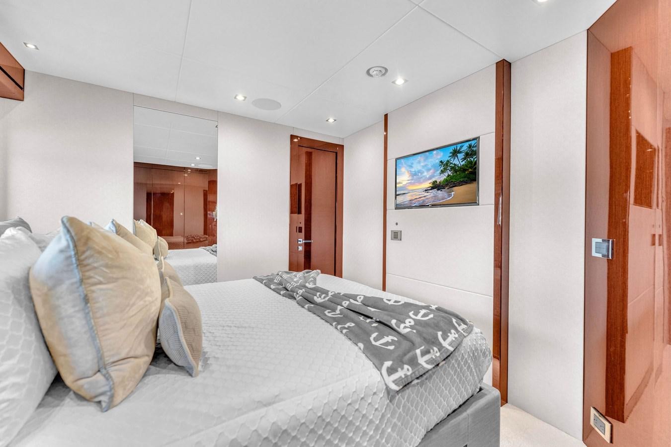 a bedroom with a bed and a television aboard 2018 SUNSEEKER 95 YACHT Yacht for Sale