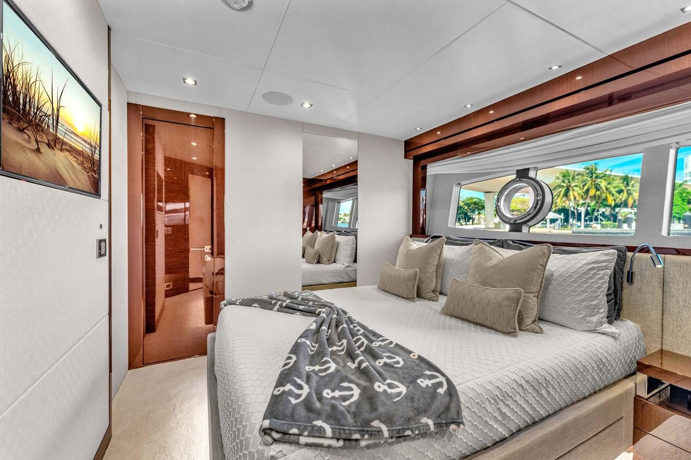 a bedroom with a bed and a large window aboard 2018 SUNSEEKER 95 YACHT Yacht for Sale