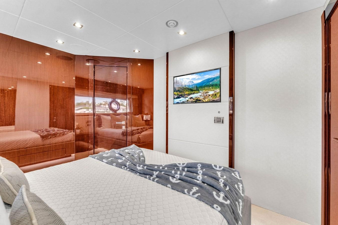 a bedroom with a bed and a glass door aboard 2018 SUNSEEKER 95 YACHT Yacht for Sale