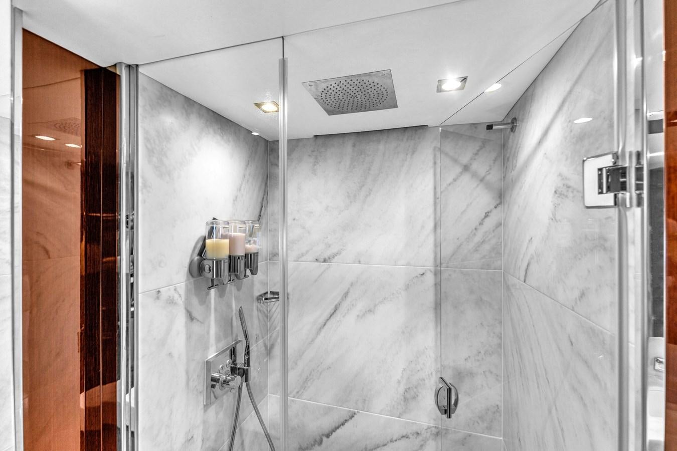 a shower with a tile wall aboard 2018 SUNSEEKER 95 YACHT Yacht for Sale