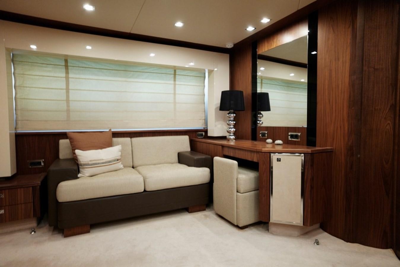 a living room with a couch and a desk aboard SUNSEEKER PREDATOR 92 Yacht for Sale