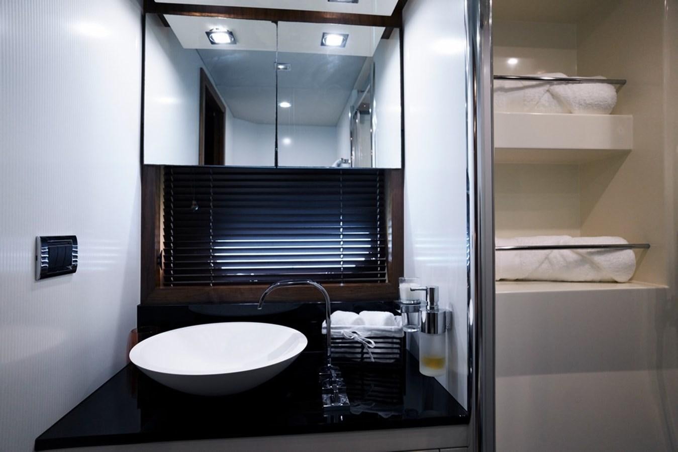 a bathroom with a sink and a mirror aboard SUNSEEKER PREDATOR 92 Yacht for Sale