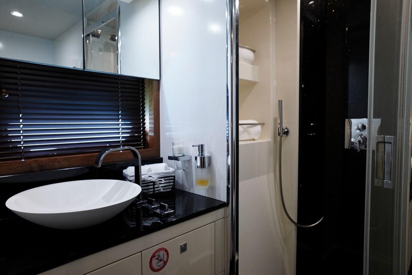 a bathroom with a sink and a mirror aboard SUNSEEKER PREDATOR 92 Yacht for Sale