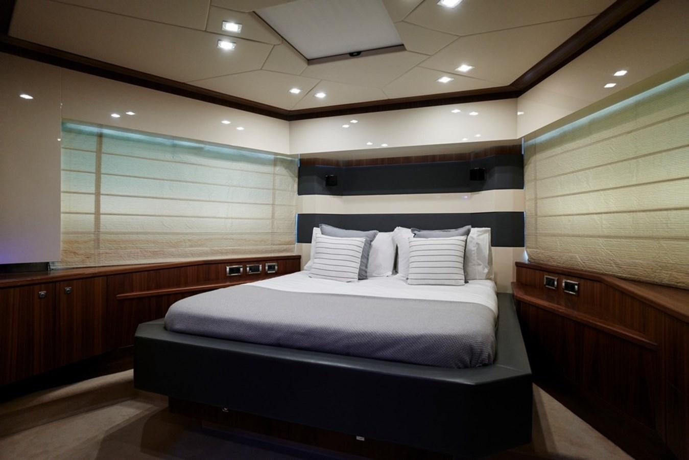 a room with a bed and a window aboard SUNSEEKER PREDATOR 92 Yacht for Sale