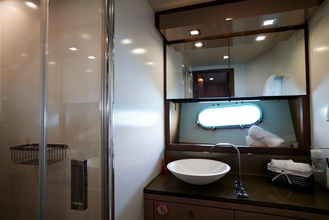 a bathroom with a large mirror aboard SUNSEEKER PREDATOR 92 Yacht for Sale