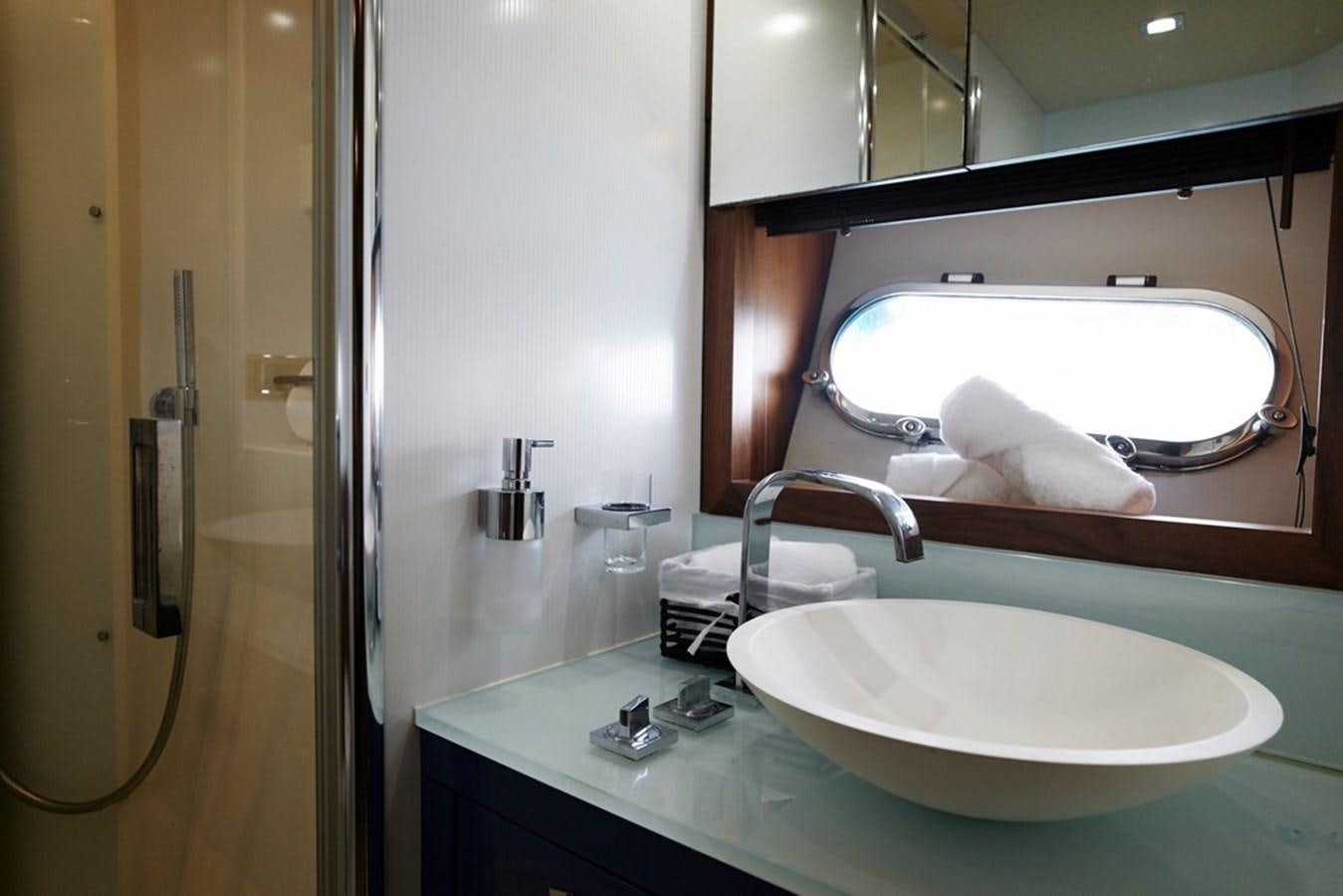 a bathroom with a sink and a mirror aboard SUNSEEKER PREDATOR 92 Yacht for Sale