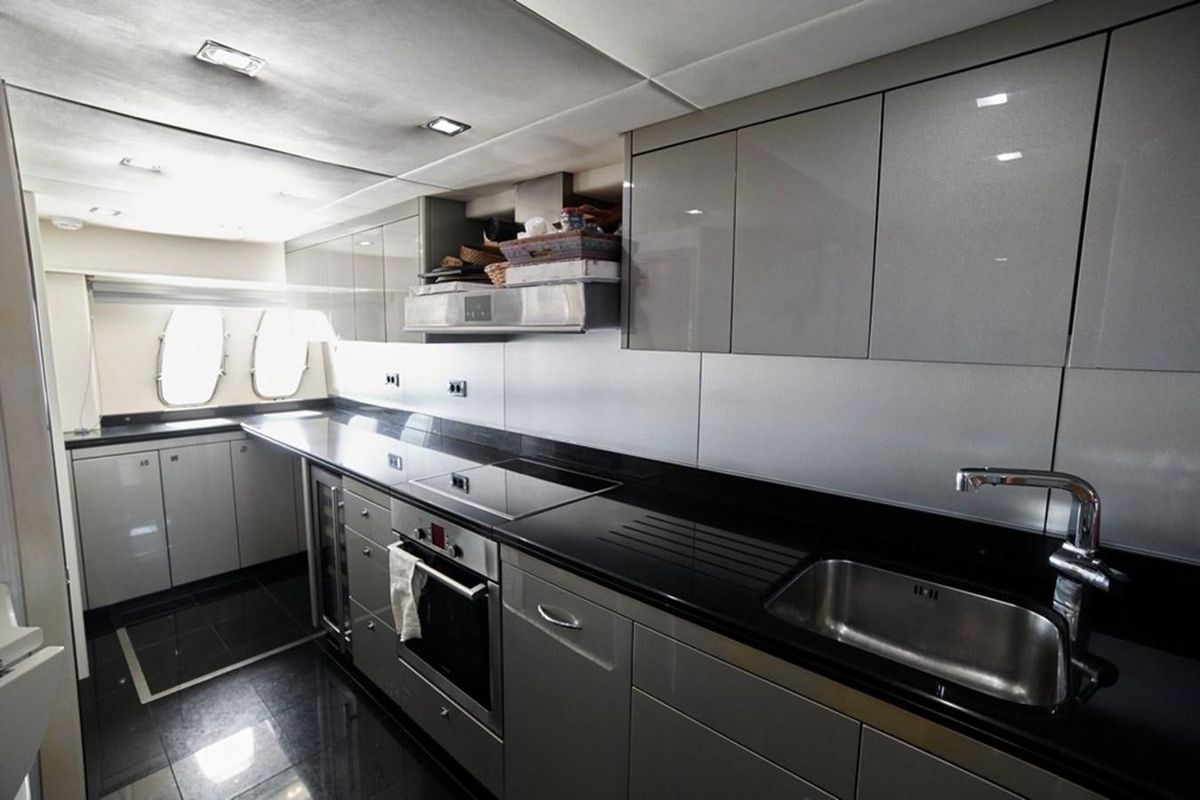 a kitchen with stainless steel appliances aboard SUNSEEKER PREDATOR 92 Yacht for Sale