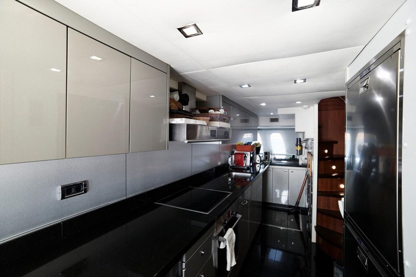 a kitchen with a large refrigerator aboard SUNSEEKER PREDATOR 92 Yacht for Sale