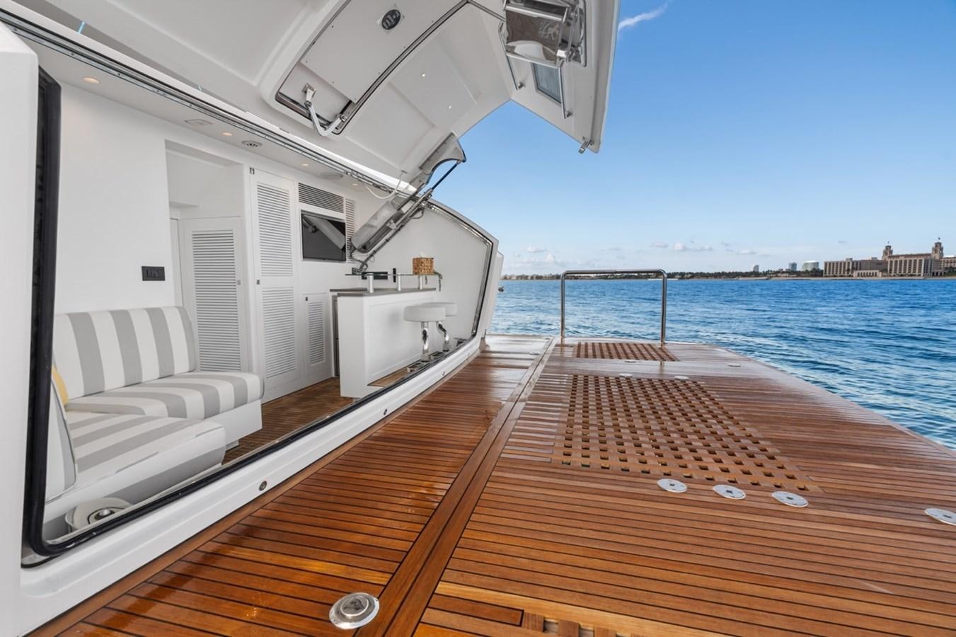 a deck with a view of the water and a boat on it aboard JEMILY II Yacht for Sale