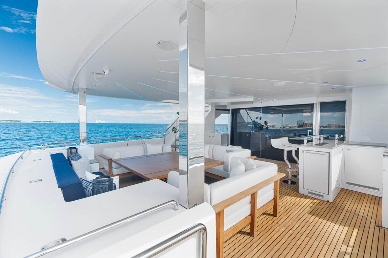 a room with a bed and a table and chairs aboard JEMILY II Yacht for Sale