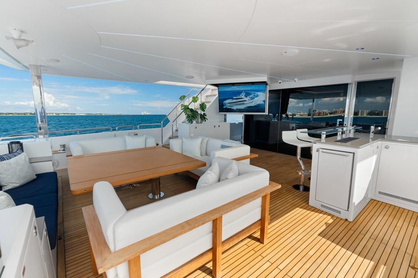 a room with a couch and a table and a tv aboard JEMILY II Yacht for Sale