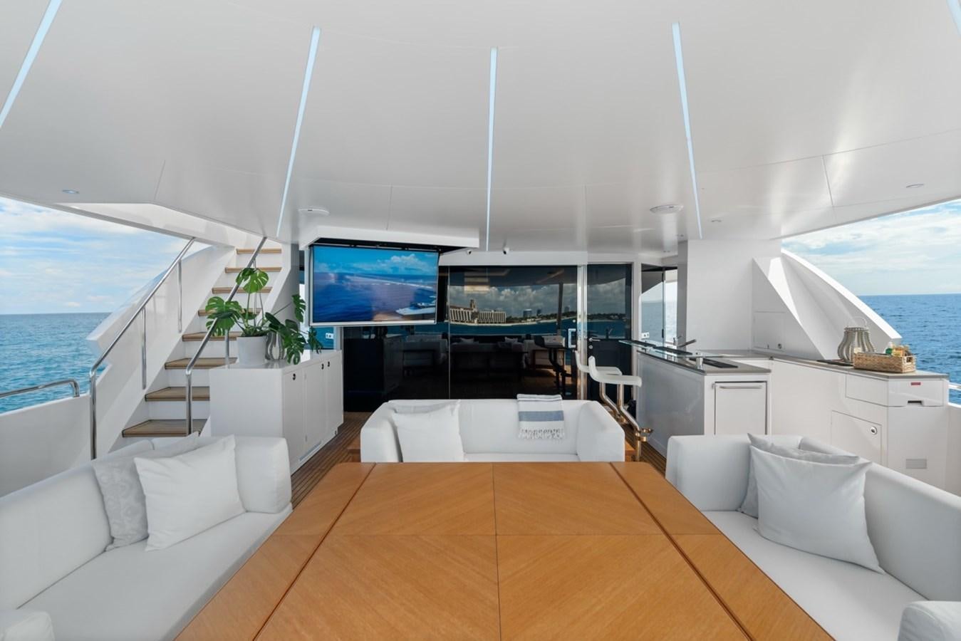 a living room with a large tv aboard JEMILY II Yacht for Sale