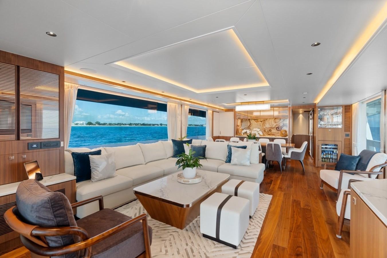 a living room with a large window aboard JEMILY II Yacht for Sale