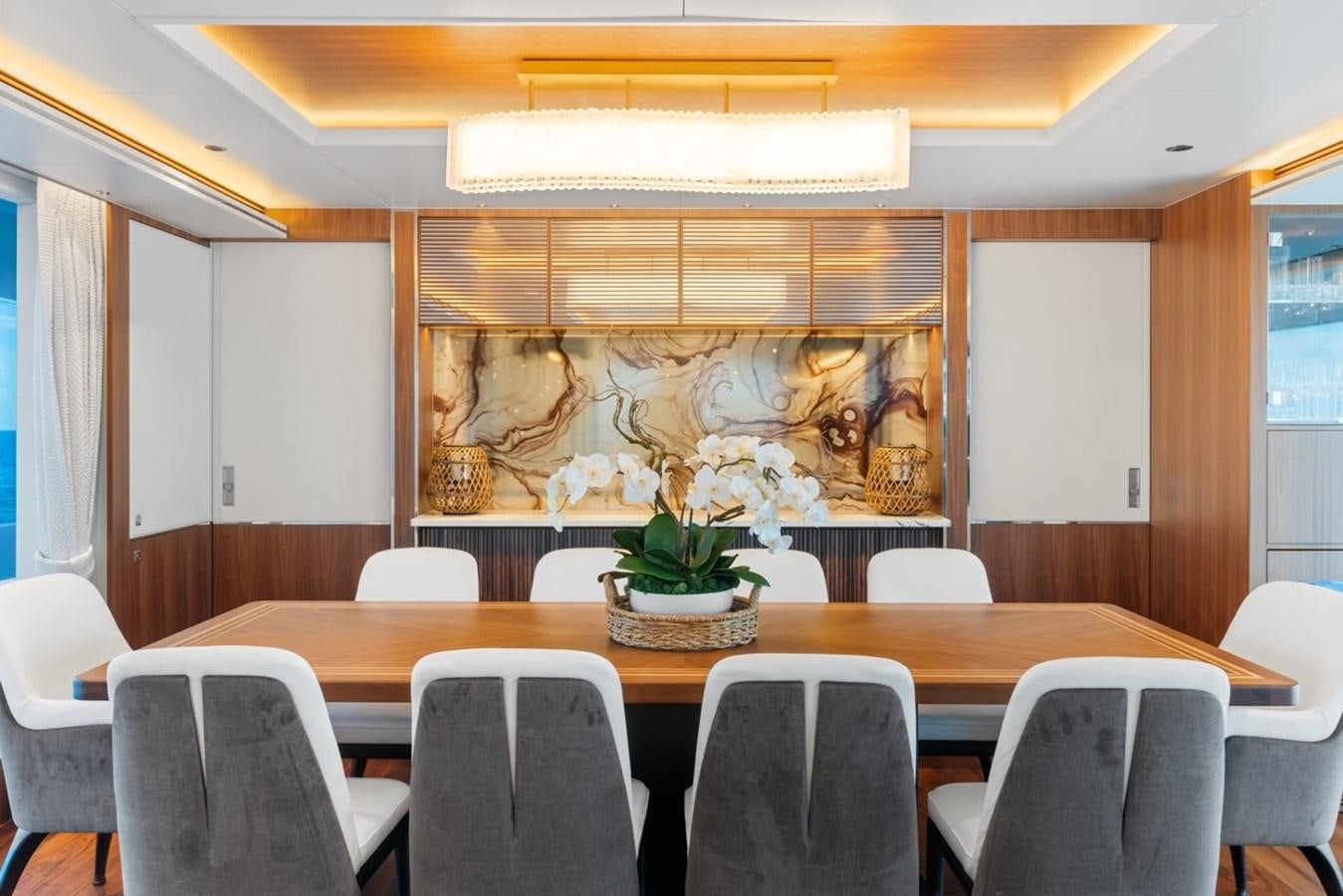 a room with a table and chairs aboard JEMILY II Yacht for Sale