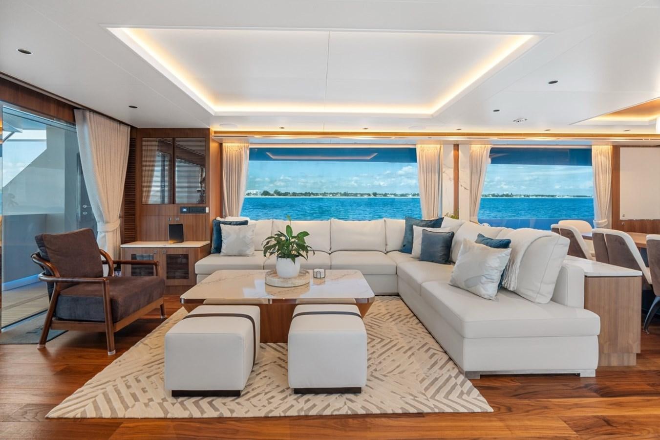 a living room with a large window aboard JEMILY II Yacht for Sale