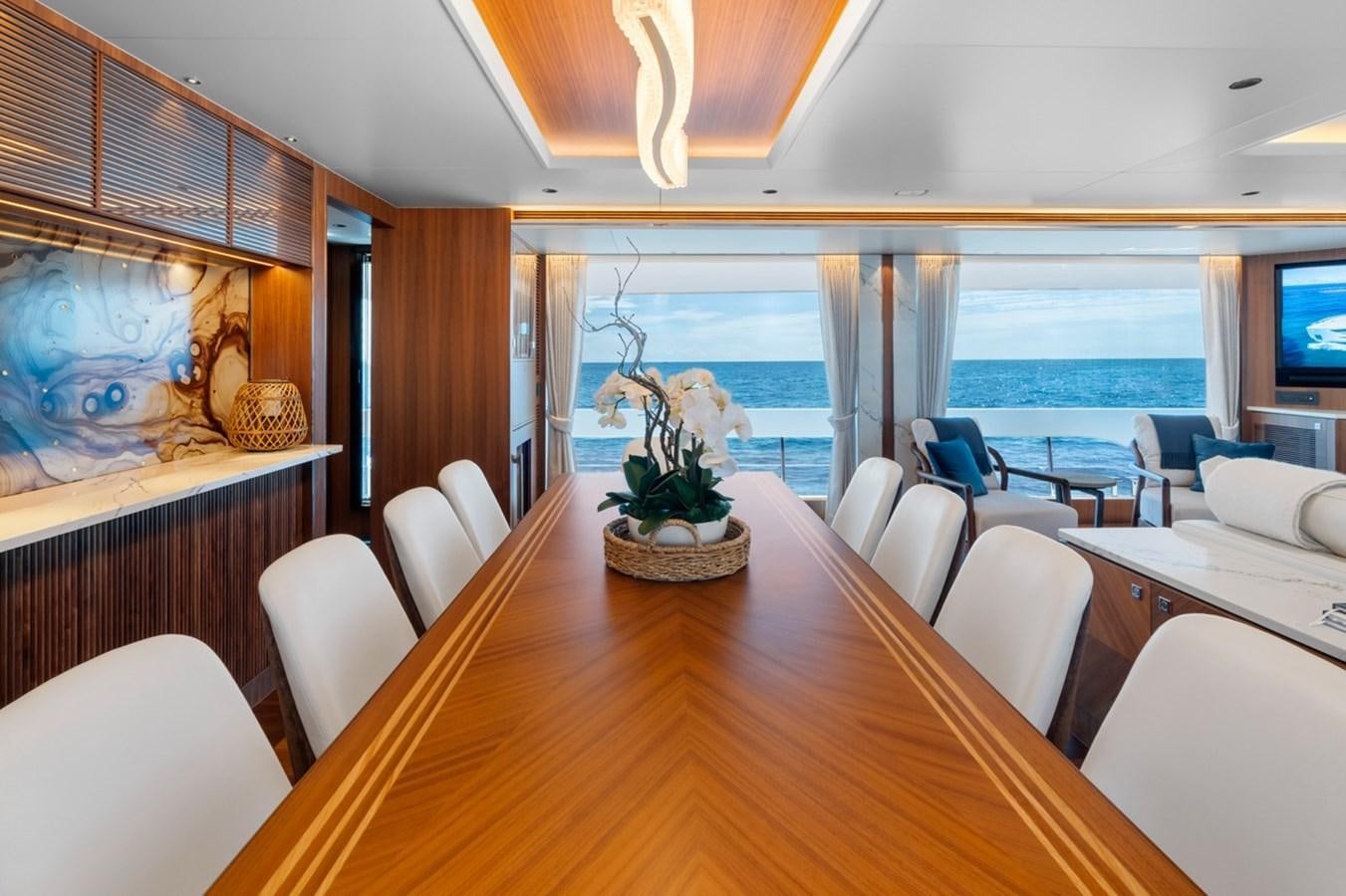 a large dining table in a room aboard JEMILY II Yacht for Sale