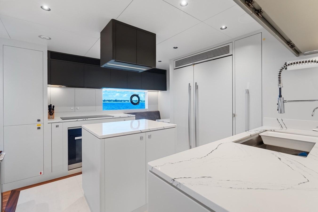 a kitchen with white cabinets aboard JEMILY II Yacht for Sale