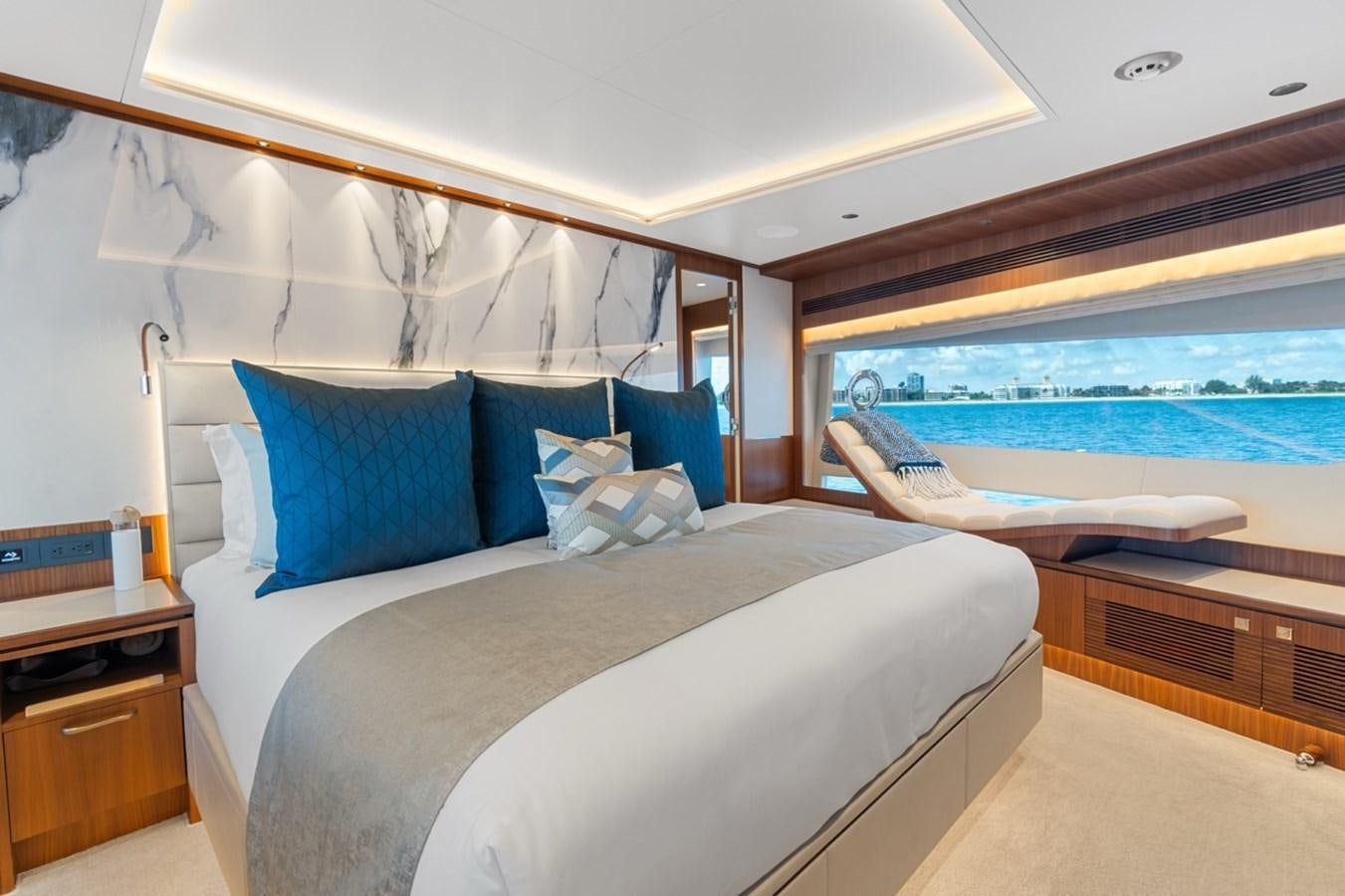 a bed with a blue pillow aboard JEMILY II Yacht for Sale