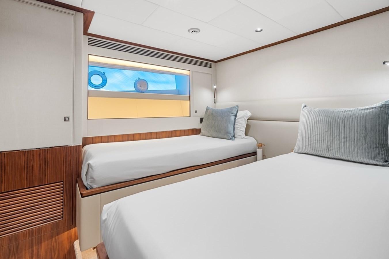 a bed with a white bed spread aboard JEMILY II Yacht for Sale