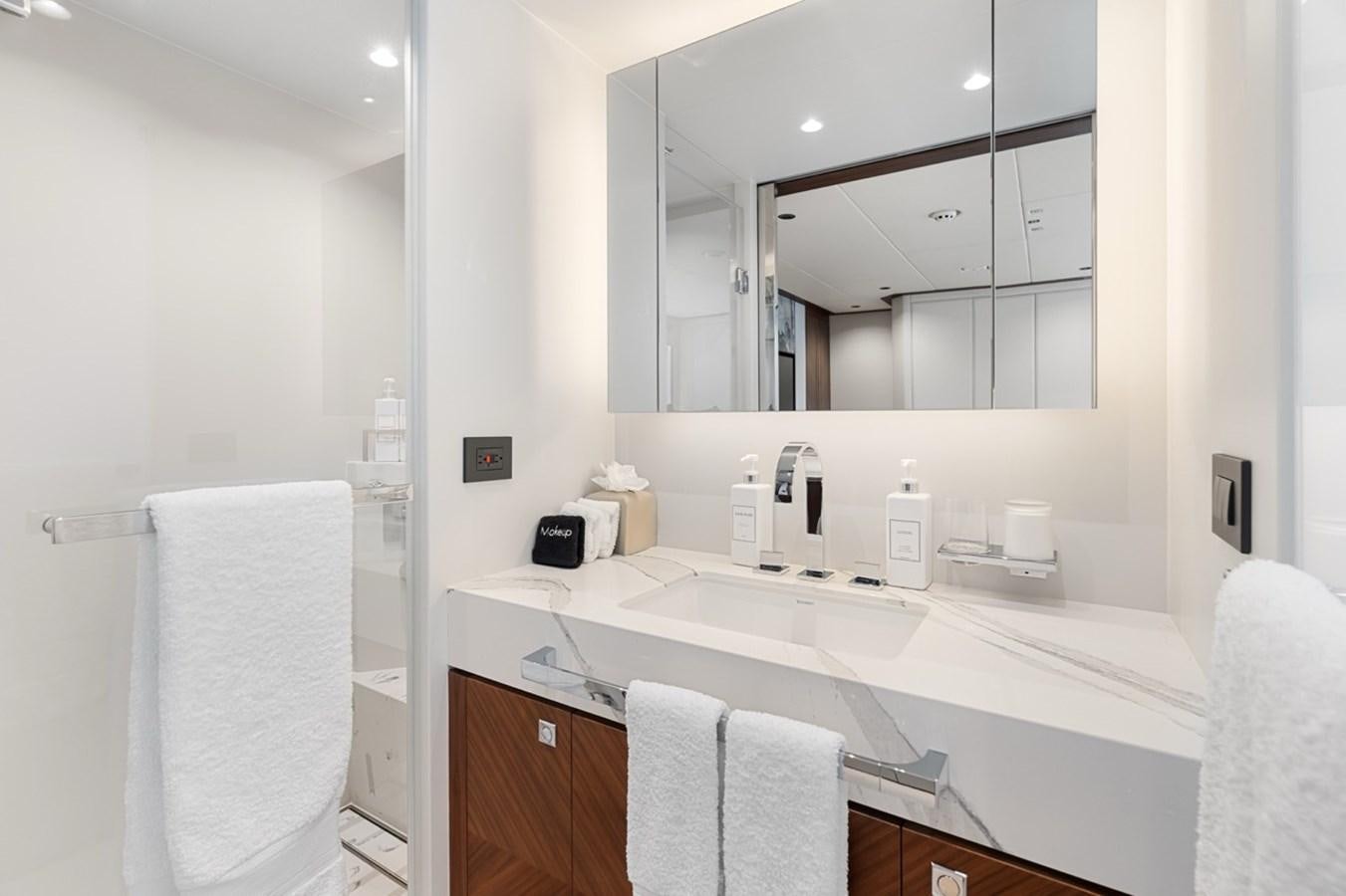 a bathroom with a large mirror aboard JEMILY II Yacht for Sale