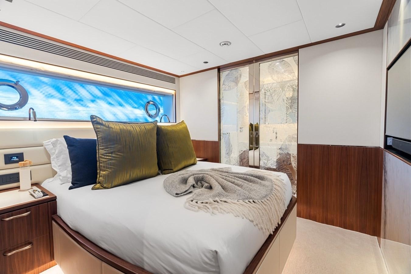 a room with a bed and a window aboard JEMILY II Yacht for Sale