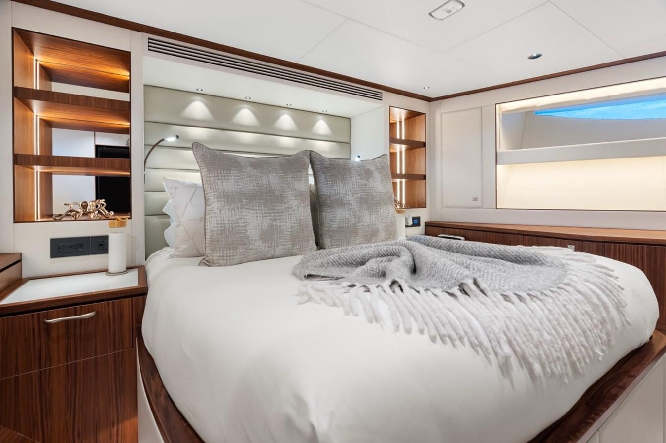 a bed with a white comforter aboard JEMILY II Yacht for Sale