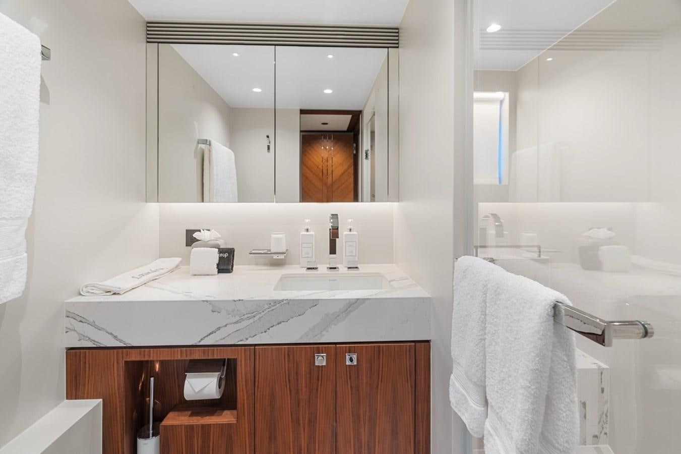 a bathroom with a large mirror aboard JEMILY II Yacht for Sale