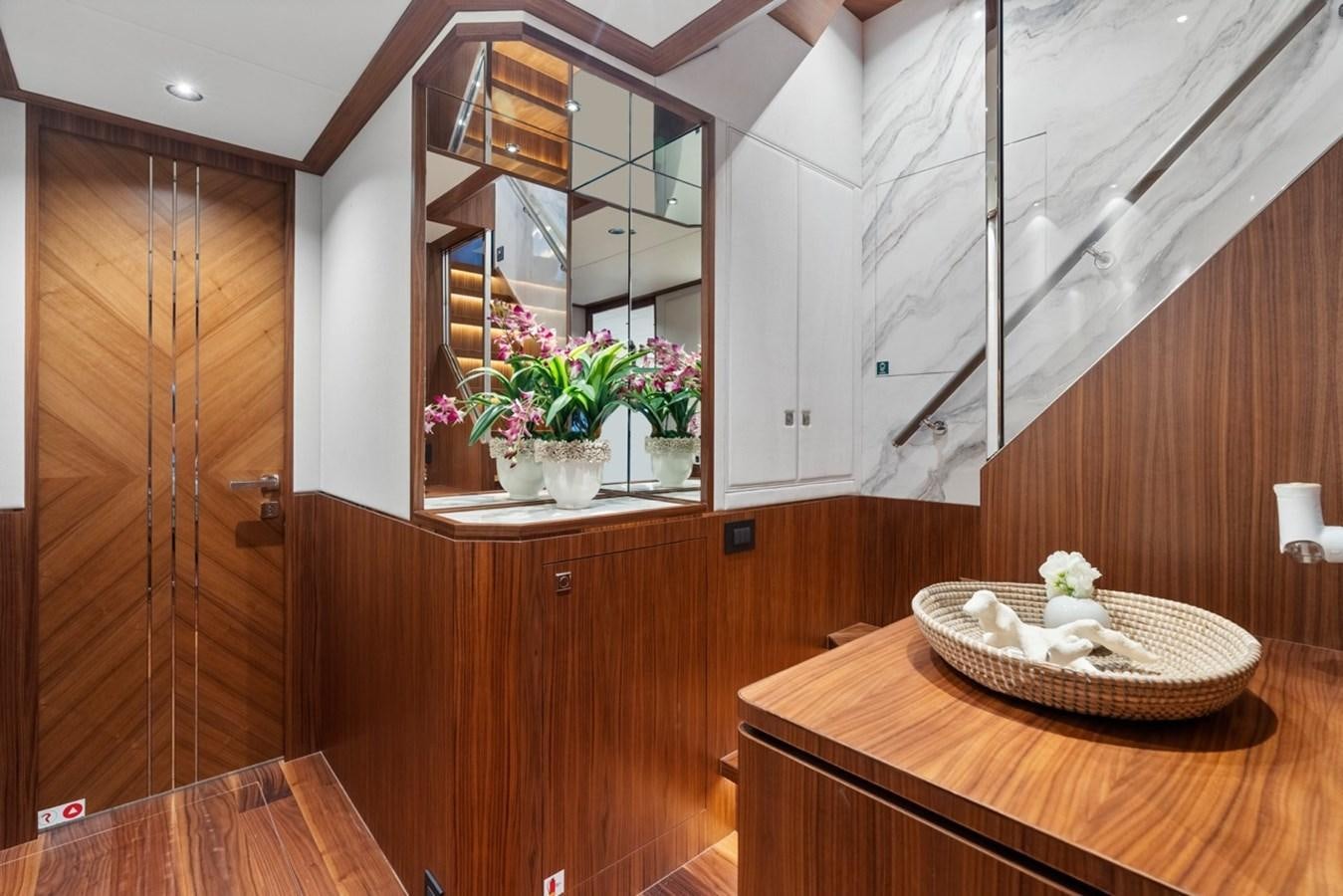 a wooden room with a mirror and a basket on a shelf aboard JEMILY II Yacht for Sale