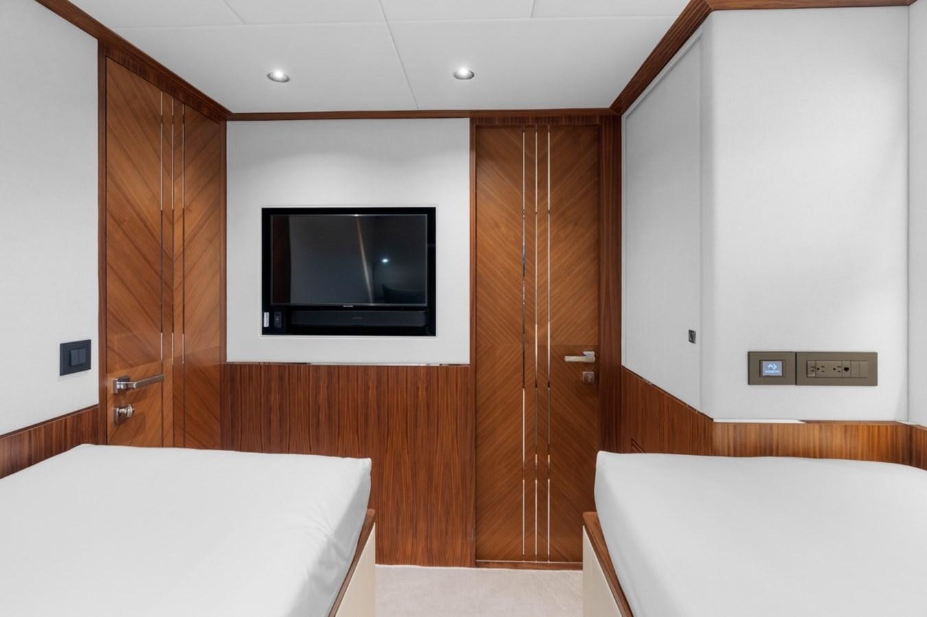 a room with a bed and a television aboard JEMILY II Yacht for Sale