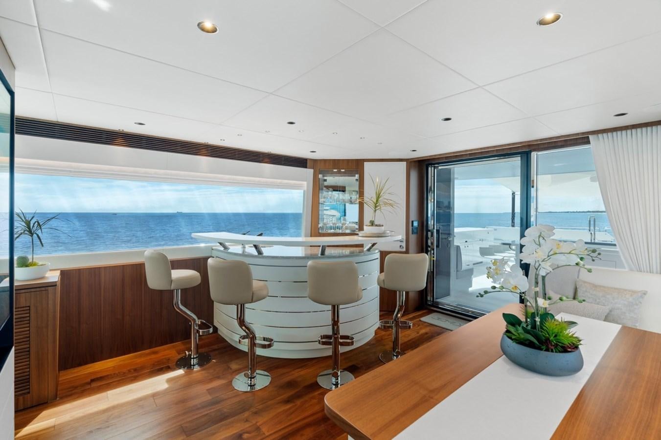 a room with a table chairs and a large window aboard JEMILY II Yacht for Sale