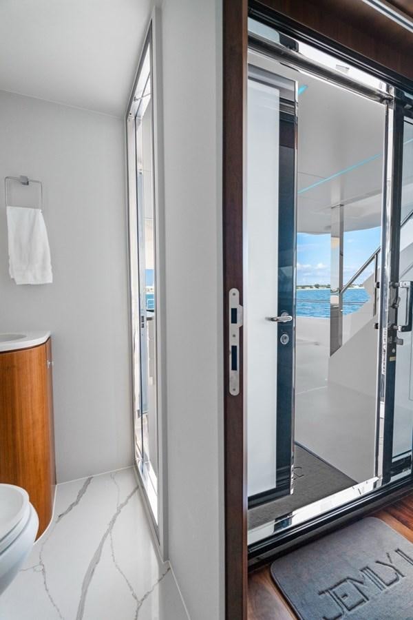 a bathroom with a glass shower aboard JEMILY II Yacht for Sale