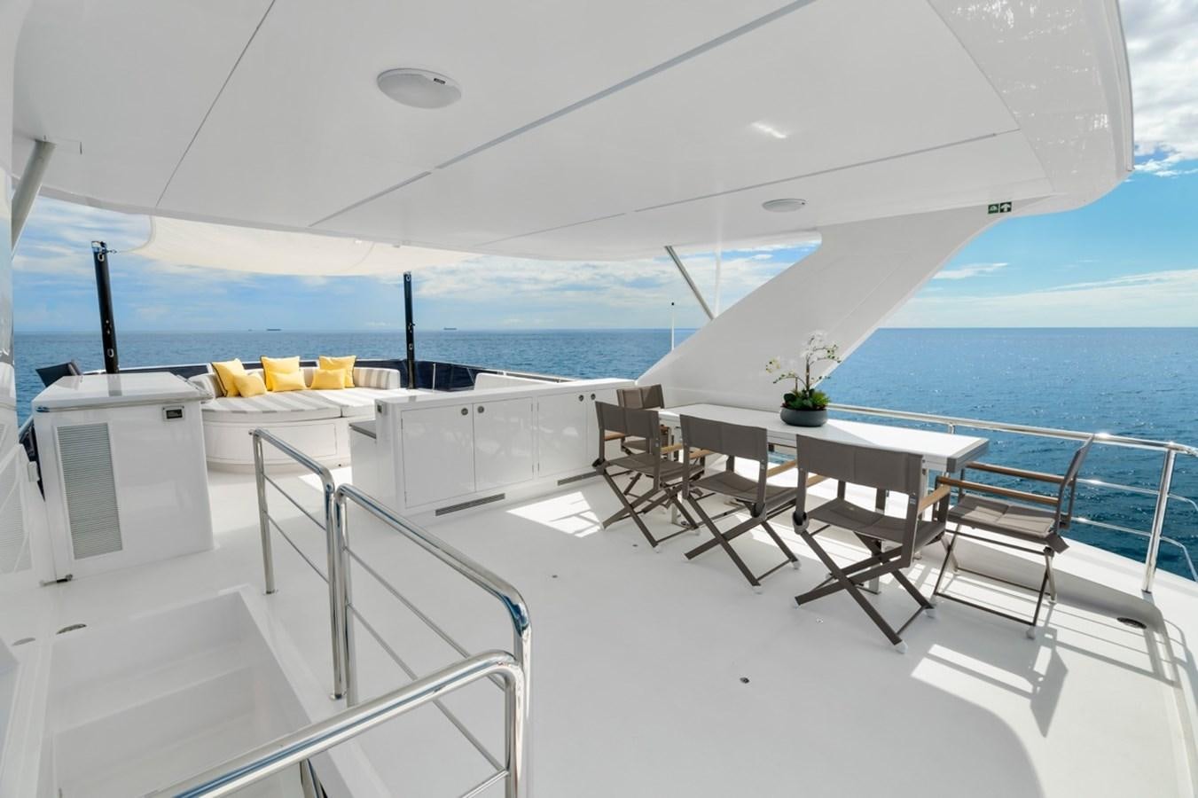a room with a table chairs and a large body of water aboard JEMILY II Yacht for Sale