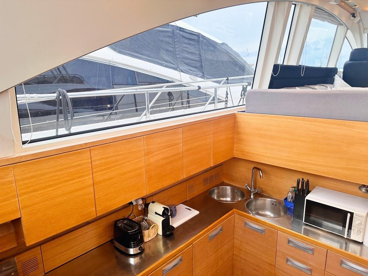 a kitchen with a large window aboard MEMORY Yacht for Sale