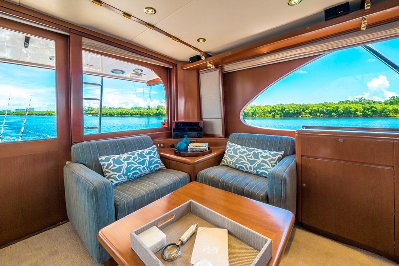 a living room with a large window aboard THANKS BUDS Yacht for Sale