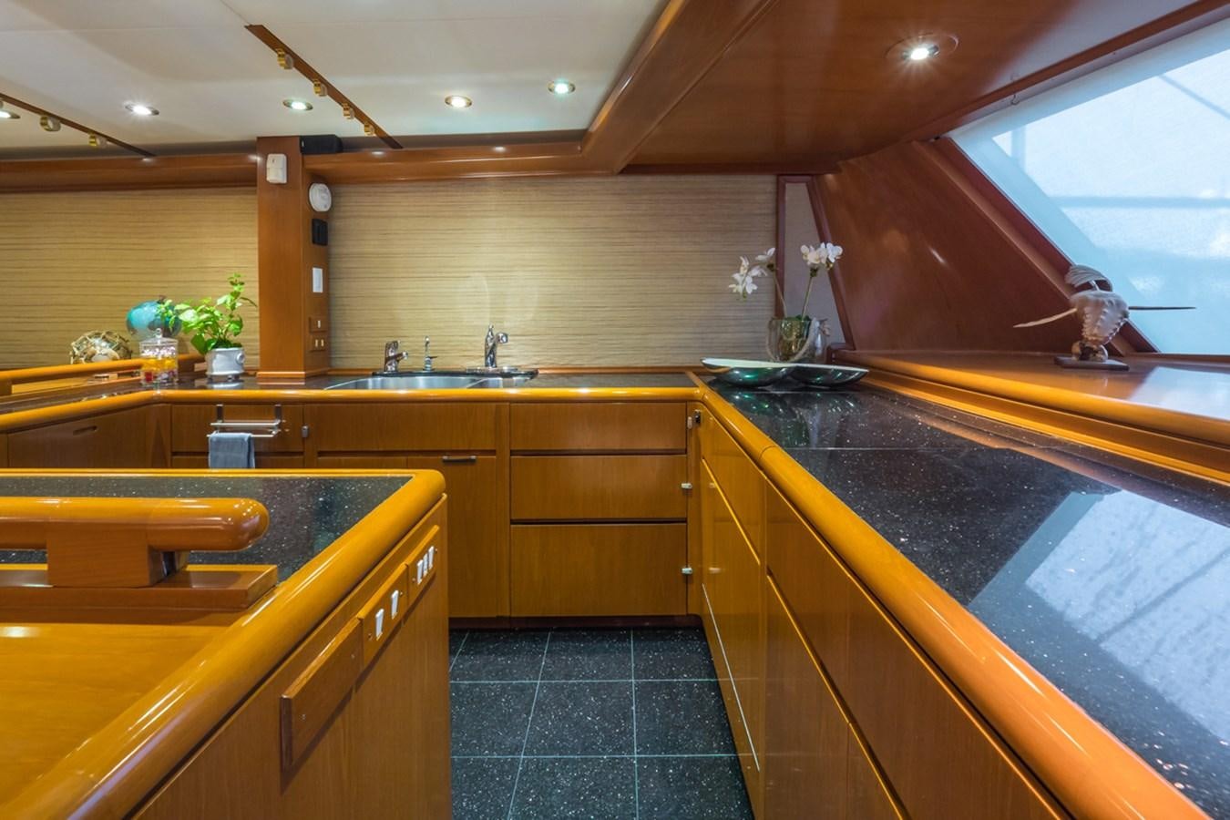 a kitchen with wooden cabinets aboard THANKS BUDS Yacht for Sale