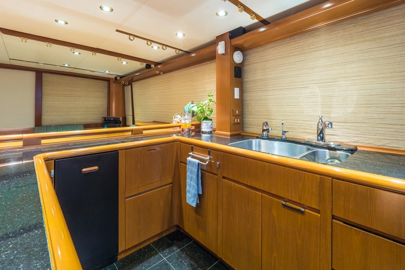 a kitchen with wooden cabinets aboard THANKS BUDS Yacht for Sale