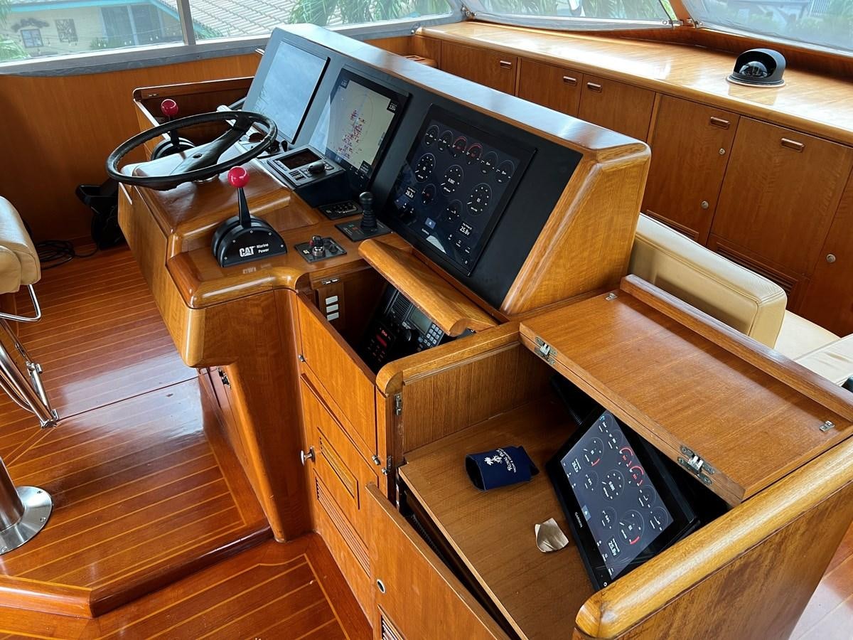a wooden desk with a computer and other electronics on it aboard THANKS BUDS Yacht for Sale